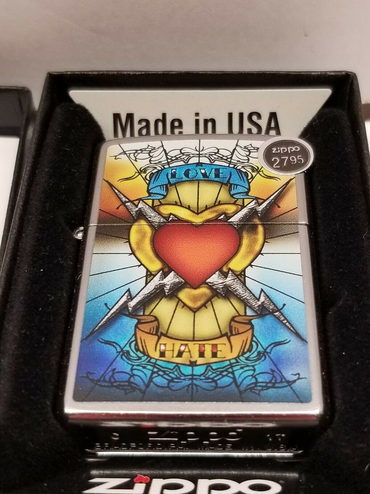 Love and Hate Zippo 2017 Mib and new condition, Never lit with sticker. Very cool graphic!